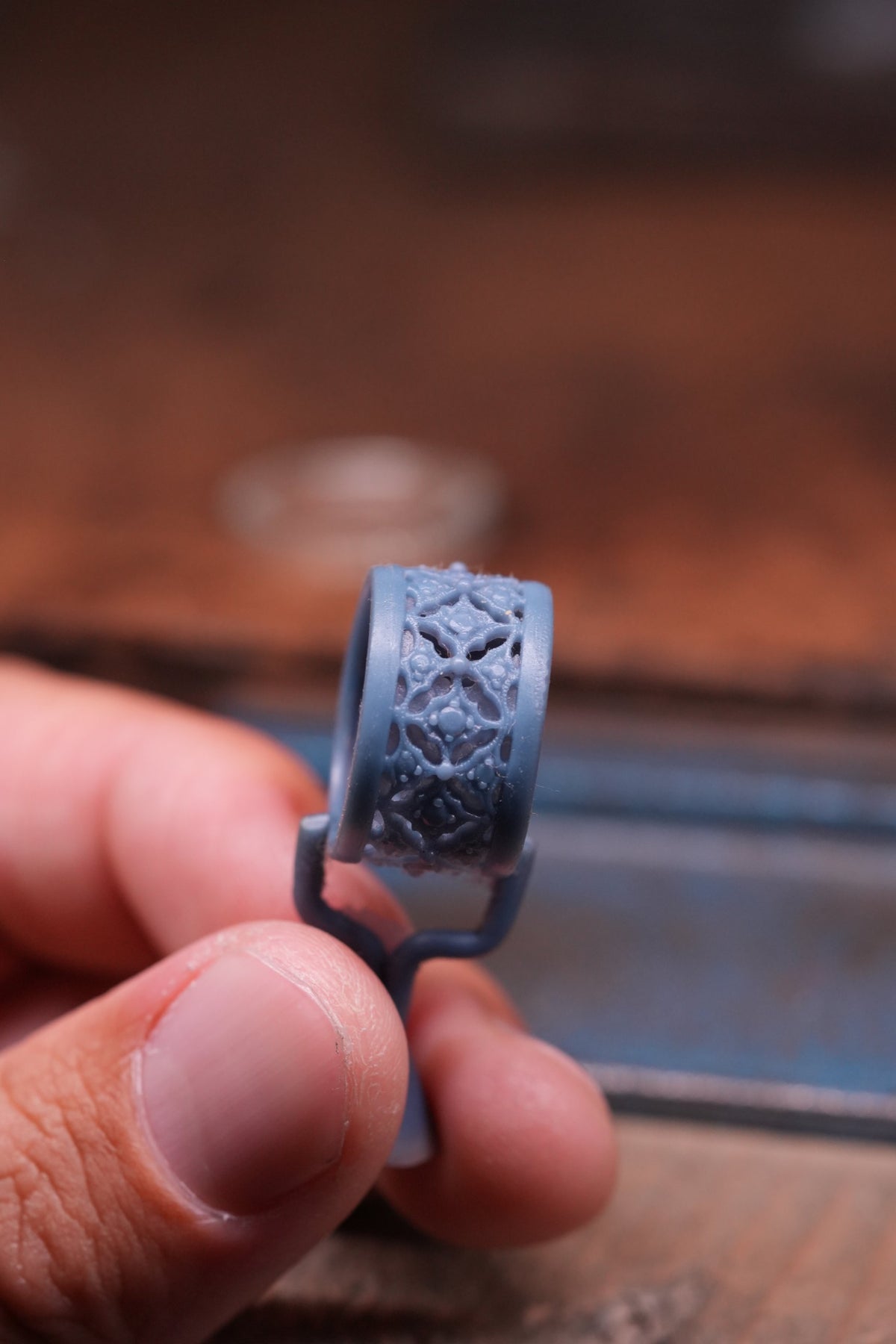 3D printed wax resin model of a custom filigree band at the jeweler bench