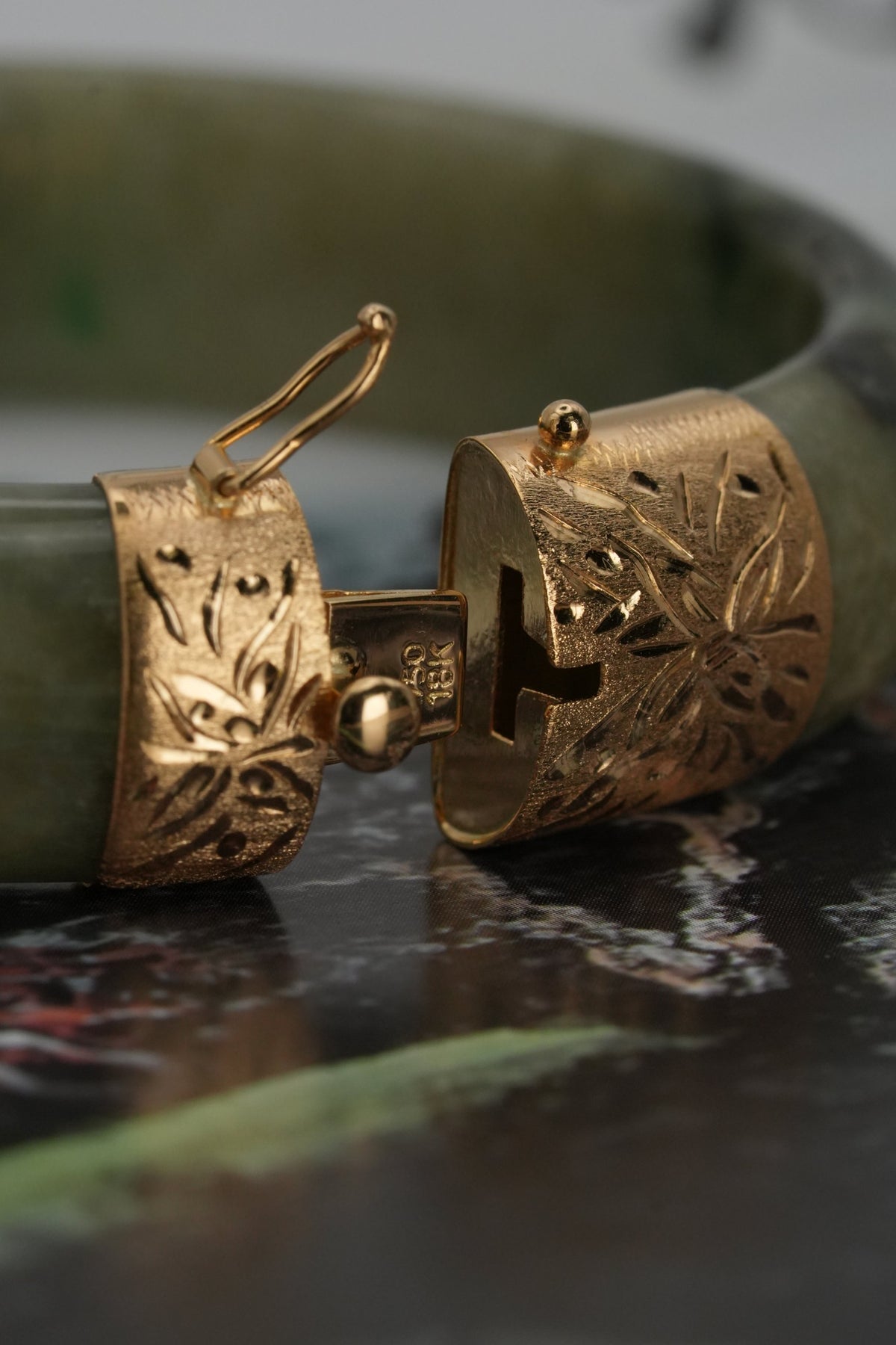Jade bangle with hand-engraved floral 18K gold caps and box clasp